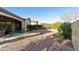 The backyard features desert landscaping with a rock drainage bed and mature foliage at 4214 E Donato Dr, Gilbert, AZ 85298