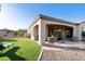 Open patio with a dining table and chairs, overlooking a well-landscaped yard at 4214 E Donato Dr, Gilbert, AZ 85298
