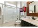 Well-lit bathroom with tub-shower combo, vanity, and decorative mirror at 4214 E Donato Dr, Gilbert, AZ 85298