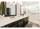 Bathroom features double sinks, framed mirrors, and a glass enclosed shower at 4214 E Donato Dr, Gilbert, AZ 85298