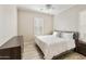 Comfortable bedroom featuring light floors, ceiling fan, and shuttered window at 4214 E Donato Dr, Gilbert, AZ 85298