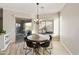 Dining area features modern chandelier, outdoor view, and access to the patio at 4214 E Donato Dr, Gilbert, AZ 85298