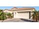 Attached garage with concrete driveway and desert landscaping in the front yard at 4214 E Donato Dr, Gilbert, AZ 85298