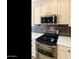 Close up view of kitchen oven, microwave, and white cabinets with bronze hardware at 4214 E Donato Dr, Gilbert, AZ 85298