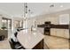 Open kitchen with center island, white cabinets, dining area, and stainless steel appliances at 4214 E Donato Dr, Gilbert, AZ 85298