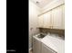 Convenient laundry room with modern appliances and built-in cabinets for storage at 4214 E Donato Dr, Gilbert, AZ 85298