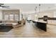 Spacious living room connects to the kitchen with barstool seating and pendant lighting at 4214 E Donato Dr, Gilbert, AZ 85298