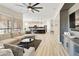 Open concept living room leading into kitchen with barstool seating and modern appliances at 4214 E Donato Dr, Gilbert, AZ 85298