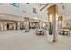 Large, open lounge featuring tables and chairs for socializing, alongside game areas at 4214 E Donato Dr, Gilbert, AZ 85298