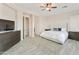 Neutral main bedroom features wood-look flooring, ceiling fan, and ensuite bath access at 4214 E Donato Dr, Gilbert, AZ 85298