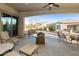 Inviting covered patio with comfortable seating and views of the landscaped backyard at 4214 E Donato Dr, Gilbert, AZ 85298