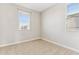 This neutral bedroom features beige carpet, fresh paint and dual windows that provide ample light at 5850 E Ringtail Way, Phoenix, AZ 85054