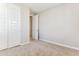 This freshly painted bedroom has two white doors, baseboards, and neutral colored carpet at 5850 E Ringtail Way, Phoenix, AZ 85054