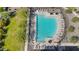 Aerial view of a pristine community pool surrounded by lush landscaping and comfortable lounge chairs at 5850 E Ringtail Way, Phoenix, AZ 85054