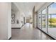 Bright hallway features tile flooring, natural light, a wet bar, and modern finishes at 5850 E Ringtail Way, Phoenix, AZ 85054
