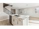 Kitchen island with a sink and dishwasher offers ample space for food prep and casual dining at 5850 E Ringtail Way, Phoenix, AZ 85054