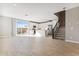 Open-concept living space with a modern kitchen and access to outdoor area at 5850 E Ringtail Way, Phoenix, AZ 85054