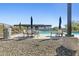 Community swimming pool with tables, umbrellas, and lounge chairs for residents at 5850 E Ringtail Way, Phoenix, AZ 85054