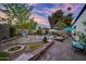 Large landscaped backyard area with shaded trees, an outdoor dining area, and a peaceful retreat at 7042 N 12Th Way, Phoenix, AZ 85020