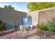Charming backyard corner with vibrant tile fountain, playful statues, and colorful potted plants at 7042 N 12Th Way, Phoenix, AZ 85020