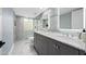 Bathroom featuring dual sinks, modern fixtures, and decorative tile at 7042 N 12Th Way, Phoenix, AZ 85020