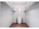 Bright, white walk-in closet with built-in shelving and ample storage space at 7042 N 12Th Way, Phoenix, AZ 85020