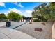 Attractive home featuring a front gate, desert landscaping, decorative rocks, exterior lighting, and a walkway to the house at 7042 N 12Th Way, Phoenix, AZ 85020