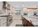 Elegant kitchen featuring marble countertops, stainless steel appliances, custom cabinetry, and a window with a pool view at 7042 N 12Th Way, Phoenix, AZ 85020