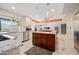 Spacious open-concept kitchen with a center island, granite countertops, stainless steel appliances, and modern lighting at 7042 N 12Th Way, Phoenix, AZ 85020