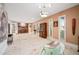 Large living room with marble floors, light neutral walls, art, built-in shelves and multiple windows at 7042 N 12Th Way, Phoenix, AZ 85020