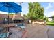 Outdoor kitchen and fireplace with stone accents, seating and a table, and lush backyard landscaping at 7042 N 12Th Way, Phoenix, AZ 85020