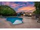 Inviting backyard oasis featuring a sparkling pool, BBQ, lounge chairs, and meticulously maintained greenery at 7042 N 12Th Way, Phoenix, AZ 85020