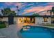 Relaxing backyard with a sparkling pool, covered patio, and serene outdoor living space at 7042 N 12Th Way, Phoenix, AZ 85020