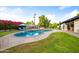 Sparkling pool with an outdoor kitchen and ample seating, perfect for outdoor entertaining and relaxation at 7042 N 12Th Way, Phoenix, AZ 85020