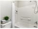 Clean white bathroom with tub, shower, and built-in storage at 706 W Green Tree Dr, San Tan Valley, AZ 85143