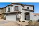 Two-story home boasts a neutral stucco exterior, two-car garage, and easy-care landscaping at 706 W Green Tree Dr, San Tan Valley, AZ 85143