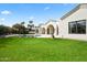 Expansive backyard featuring a refreshing pool, manicured lawn, and views of lush greenery at 7157 E Bronco Dr, Paradise Valley, AZ 85253