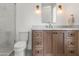 Elegant bathroom with a wood vanity cabinet, marble countertop, and modern fixtures at 7157 E Bronco Dr, Paradise Valley, AZ 85253