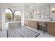 Elegant bathroom boasts dual sinks, makeup vanity, soaking tub, and beautiful decorative tile flooring at 7157 E Bronco Dr, Paradise Valley, AZ 85253