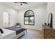 Bright bedroom featuring a decorative window overlooking a lush yard, and wood flooring at 7157 E Bronco Dr, Paradise Valley, AZ 85253