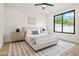 Neutral bedroom with a large window, modern decor, and minimalist artwork at 7157 E Bronco Dr, Paradise Valley, AZ 85253