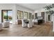 Dining area featuring wood floors, white walls, and views to the swimming pool at 7157 E Bronco Dr, Paradise Valley, AZ 85253