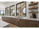 Gourmet kitchen featuring custom cabinetry, marble countertops, and open shelving details at 7157 E Bronco Dr, Paradise Valley, AZ 85253