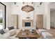 Stylish living room showcasing a fireplace, wooden beams, and a unique woven pendant light at 7157 E Bronco Dr, Paradise Valley, AZ 85253