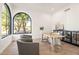 Stylish office space with a large arched window, modern desk, and comfortable seating at 7157 E Bronco Dr, Paradise Valley, AZ 85253