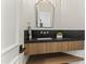 Modern powder room with floating wood vanity, vessel sink, and decorative mirror at 7157 E Bronco Dr, Paradise Valley, AZ 85253