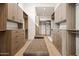 Spacious walk-in closet with custom wood shelving and drawers, plus a center ottoman at 7157 E Bronco Dr, Paradise Valley, AZ 85253