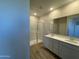 The bathroom features double sinks, white countertops, and a glass-enclosed shower at 7272 E Hackamore Ln, San Tan Valley, AZ 85143