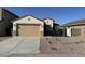 Charming single-story home with a two-car garage and desert landscaping in front at 7272 E Hackamore Ln, San Tan Valley, AZ 85143
