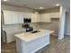 Modern kitchen featuring white cabinets, an island, and stainless steel appliances at 7272 E Hackamore Ln, San Tan Valley, AZ 85143